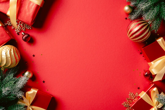 Red Christmas gifts and baubles corner frame on red background