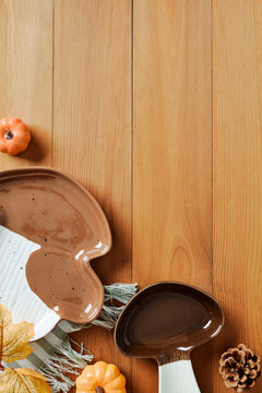 Autumn ceramic mushroom dishes on wooden table vertical orientation