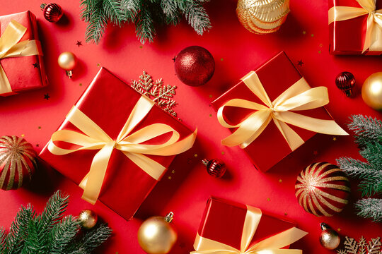 Christmas holiday background with red gift boxes and golden baubles