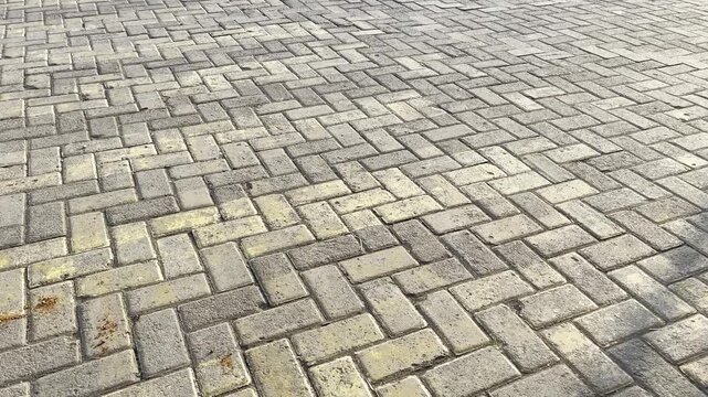 Wide view of interlocking concrete brick pavement parking space
