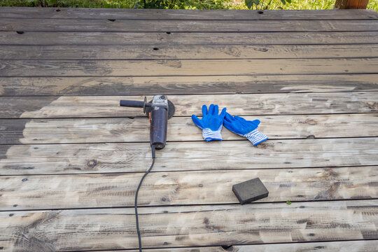 Tools laid out on aged wood, ready for manual work or renovation tasks