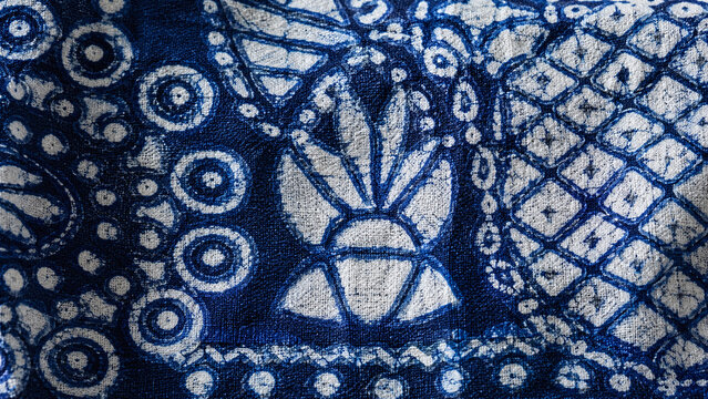 Nigerian Adire Eleko Yoruba cassava resist-dyed indigo cloth macro with vivid white resist geometric calabash diamond fan motifs on deep blue on black background