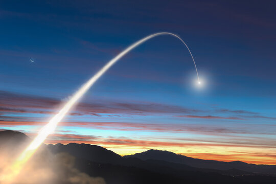 Missile launched into the morning sky over a rural mountain landscape, USA