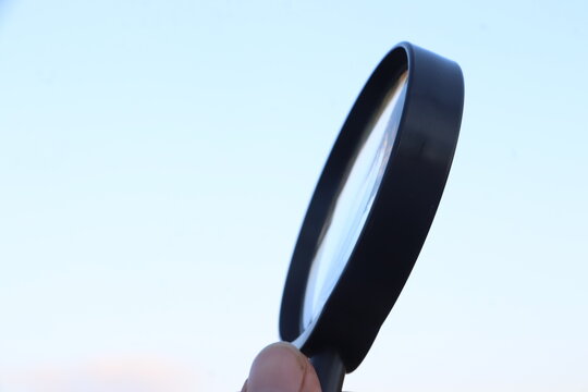 Global Discovery and Research Symbolized by a Magnifying Glass Over the Globe