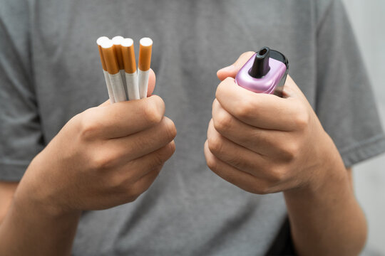 Man holding electronic cigarettes, no smoking.