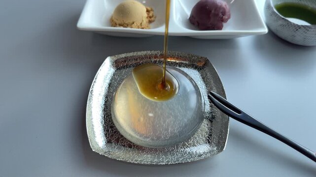 Japanese Raindrop Cake Dessert Served with Black Sugar Syrup and Kinako and matcha