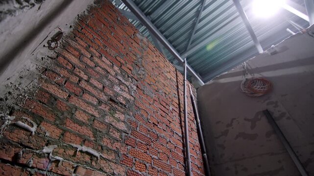 Sturdy brick masonry combined with steel support beams. Raw construction elements reflect strong architectural foundation of facility