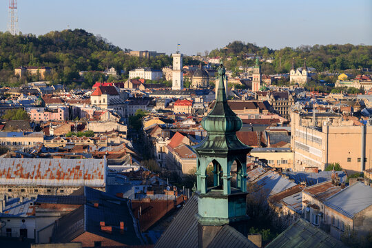 Panoramic view of an old European city with historical buildings and green hills