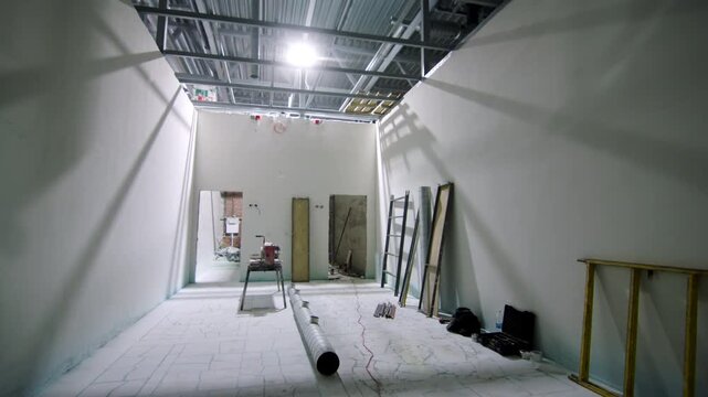Interior space prepared for ongoing engineering installation work. Concrete floor and neatly stored equipment reflect organized workflow