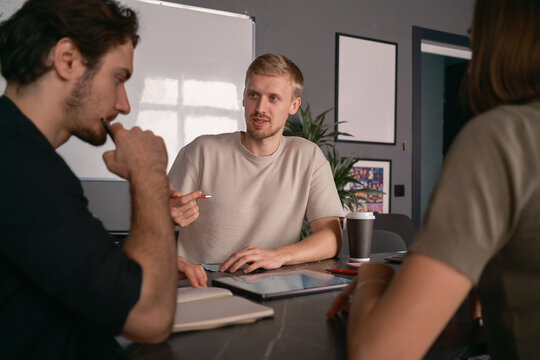 Group of colleagues collaborating during a productive business meeting in a modern office