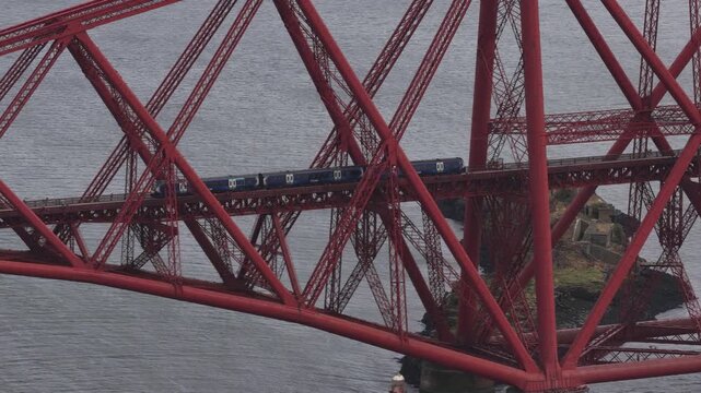 Train crossing the iconic forth rail bridge in scotland