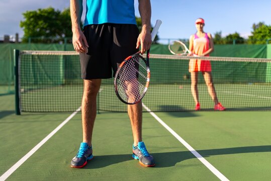 Tennis player standing at the baseline holding a racket