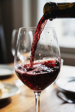 Red wine pouring into a glass