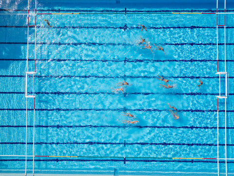 Top Down Aerial View of Water Polo Players Passing Ball During Match Game