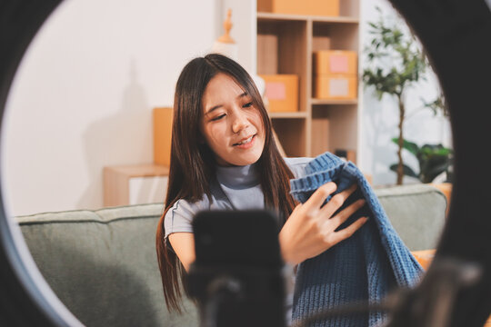 Woman recording live stream preparing packages for online selling