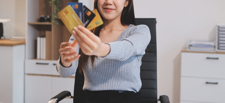Young Asian business woman using smartphone and credit card for online shopping. Online Payment.
