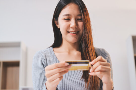 Young Asian business woman using smartphone and credit card for online shopping. Online Payment.