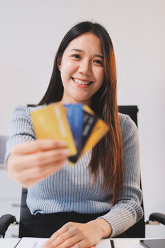 Young Asian business woman using smartphone and credit card for online shopping. Online Payment.