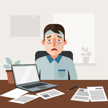 Exhausted Businessman Overwhelmed By Workload Sitting At Desk