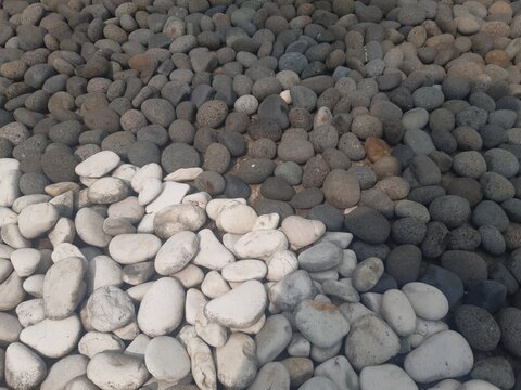 Zen pebble stones texture background with black and white contrast