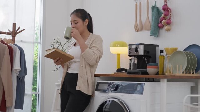 Woman kitchen coffee book washing machine home morning casual reading calm bright laundry appliance cup notebook tidy interior drink dish rack utensil pasta garlic