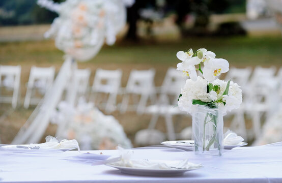 Table decoration and flowers at an outdoor wedding