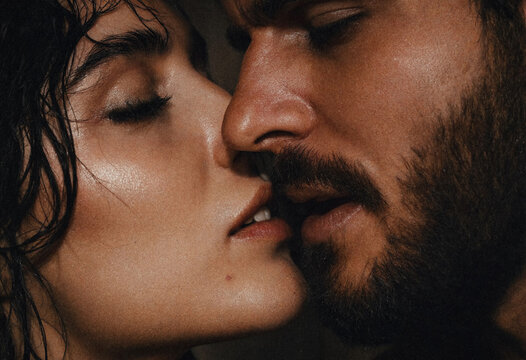 Close-up portrait of a passionate couple about to kiss with dramatic cinematic lighting