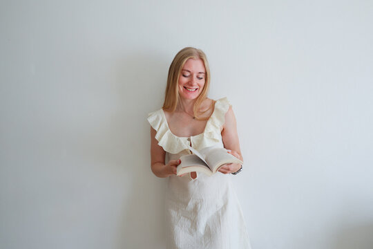 Young female reader enjoying a book indoors, relaxed everyday lifestyle and learning concept.