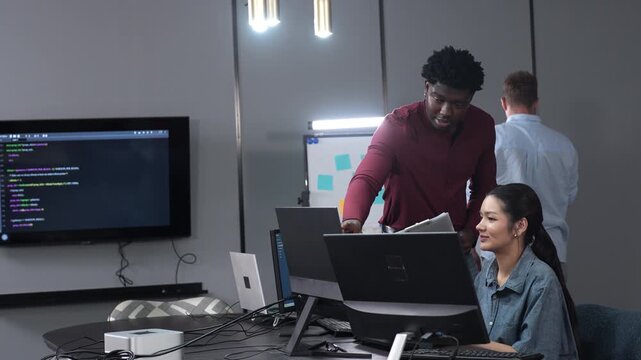 Asian happy woman and man programmer team coding software at computer in dark tech office, Concept of digital transformation, modern cyber security, startup teamwork and future IT digital network
