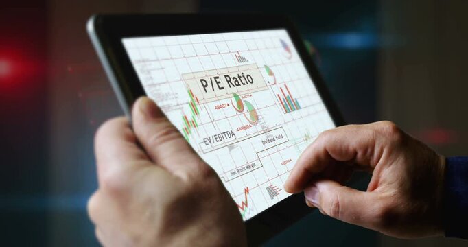 Stock market indices ebitda ratio charts and graphs diagram on touchscreen pad display. Finger touch tablet screen in hand. Digital analysis and report.