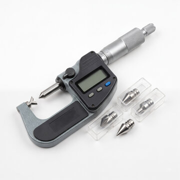 Generic digital screw thread micrometer with interchangeable V and cone anvils isolated on white.
