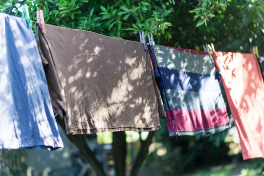 Colorful Clothes Hanging on a Clothesline in a Residential Garden
