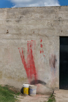 Abstract Urban Wall with Faded Graffiti and Paint Buckets
