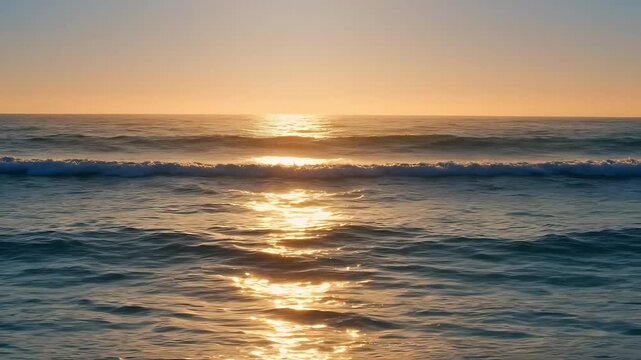 Beautiful Golden Sunset Over a Peaceful Beach with Soft Ocean Waves Gently Rolling Toward the Shore in Serene Coastal Video Footage