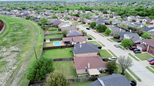 Fenced residential properties border open greenbelt along Mansfield Webb Road corridor. In ground swimming pool, rooftop solar panels, split rail fences frame neighborhood life, Arlington, Texas