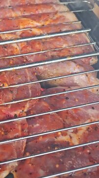 Cooking pork on the grill at a backyard barbecue in the summer