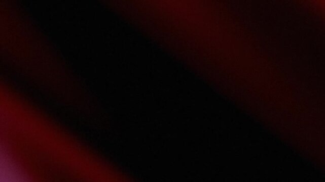 Abstract red and black diagonal background with a moody, dark texture