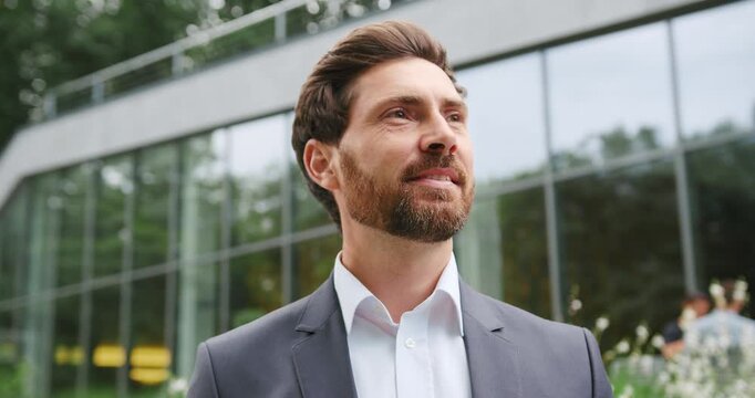 Smiling Caucasian adult man looking around outdoors