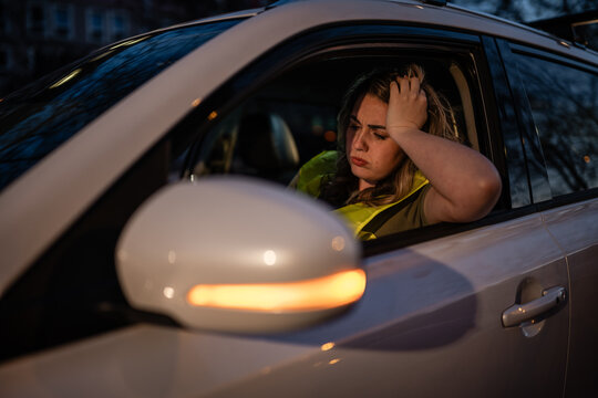Woman experiencing car trouble outdoors feeling stressed and frustrated