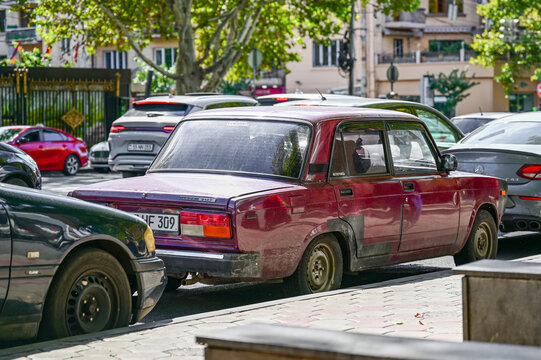 Classic wine-red Lada 2107 (VAZ-2107) parked in Yerevan city traffic; a Soviet automotive classic from the Lada Riva series (produced 1982&ndash;2012), Yerevan, Armenia 26.08.2025