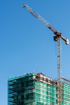 Tower Crane And Building Construction Site Against Blue Sky Urban Development Industry