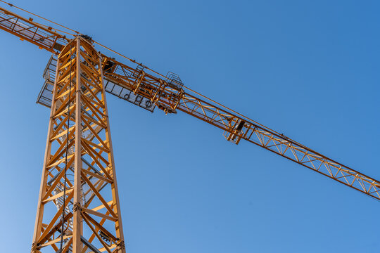 Tower Construction Crane Against Clear Blue Sky Engineering Industry And Urban Development