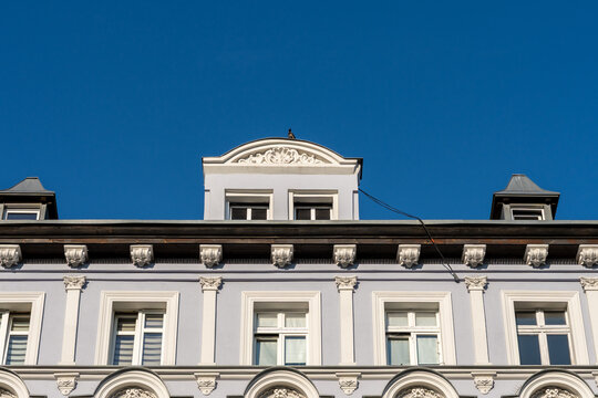 Historic Building Facade With Ornate Architecture Windows And Deep Blue Sky Urban Heritage