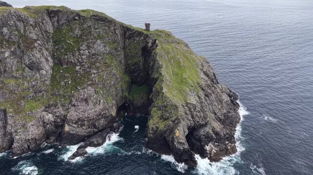 Cliffs by the sea no visible action static scene, in coastal landscape with cliffs and ocean, with cliffs, ocean, from a aerial view perspective, with green, blue accents, nearby objects.