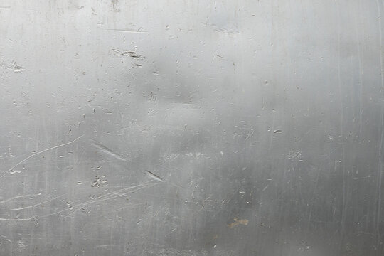 Close-Up of Scratched Brushed Aluminum Metal Surface with Water Droplets