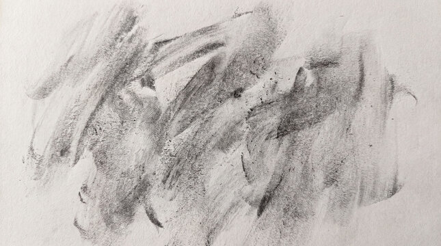 Graphite dust smeared on white paper surface with abstract texture and soft shading effect