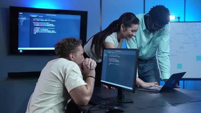 Diverse software developer team collaborating on computer code in modern IT office, Male programmers and female colleague brainstorming future technology business innovations and smart digital system