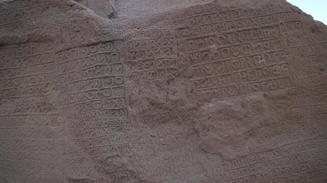 Close-up panning shot of ancient Dadanitic and Lihyanite rock inscriptions at Jabal Ikmah in AlUla