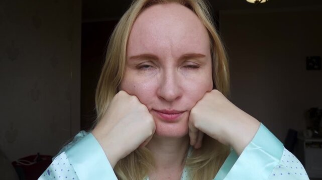 Concerned middle aged woman touching forehead wrinkles and frown lines between eyebrows. She is thinking about anti aging skincare and botox injections.
