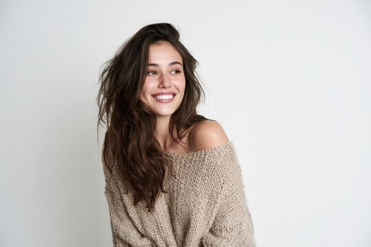 Cheerful studio portrait of a woman with a bright smile, white background and soft lighting
